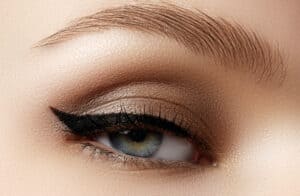 Cosmetics & make-up. Beautiful female eye with sexy black liner makeup. Fashion big arrow shape on woman's eyelid. Chic evening make-up - Beautygab