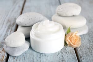 Emulsions For Skincare - Beautygab Face cream jar with spa stones and a rose, arranged as a skincare gift
