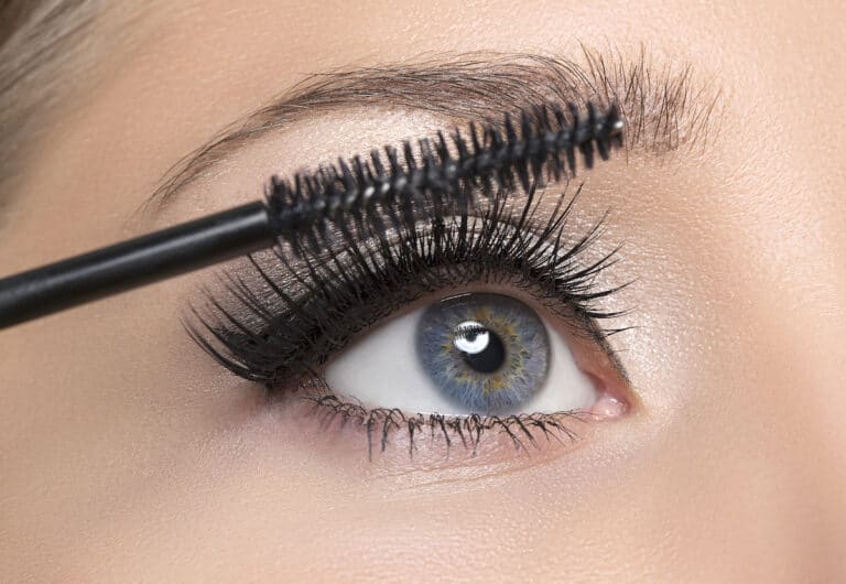 Woman With Long Eyelashes And A Mascara Spoolie