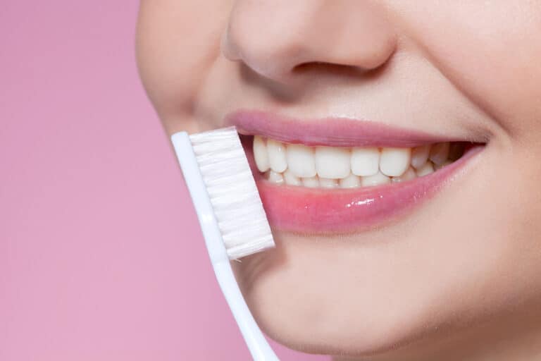 Girl With Pink Lips And A Toothbrush