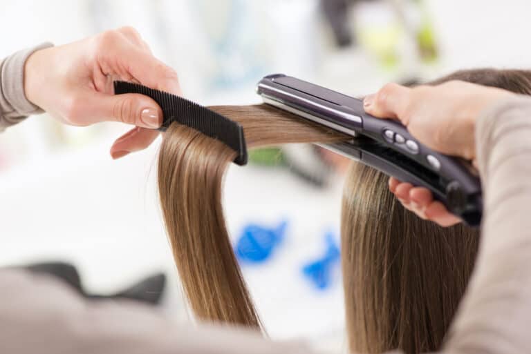 Woman Straightening Hair