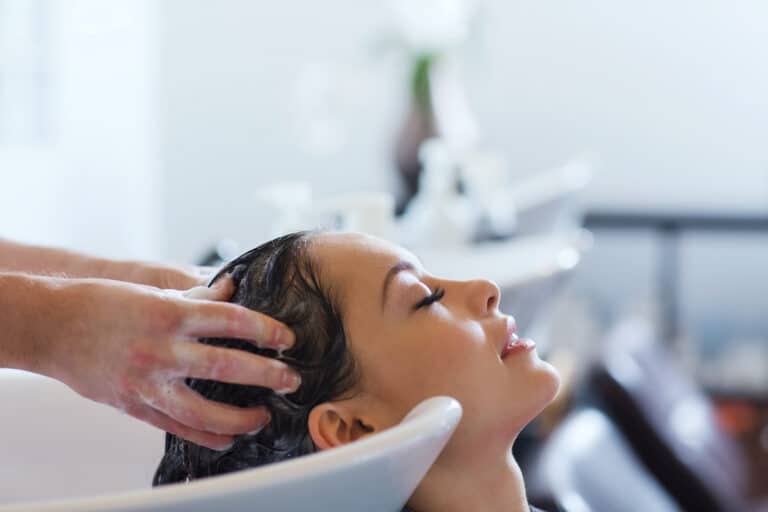 Woman Getting Her Hair Washed At Salon