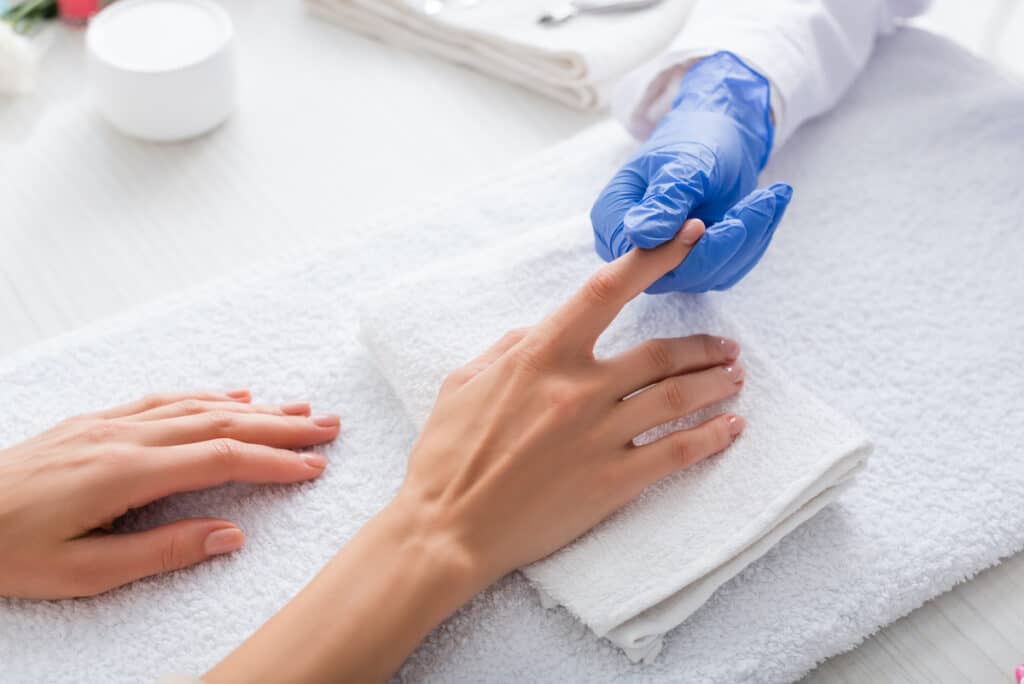 Paper Thin Nails After Acrylics - Beautygab Nail Technician Examining Nails