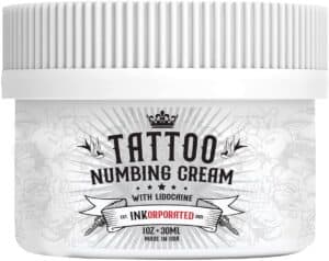 8-19 - Beautygab InKorporated tattoo numbing cream in a white jar with a black tattoo-style label