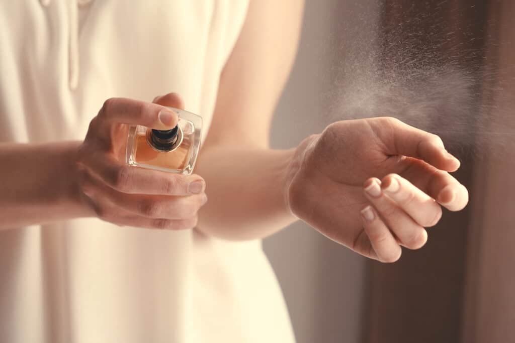 How Long Does Perfume Last On Skin and Clothes? - Beautygab Woman spraying perfume