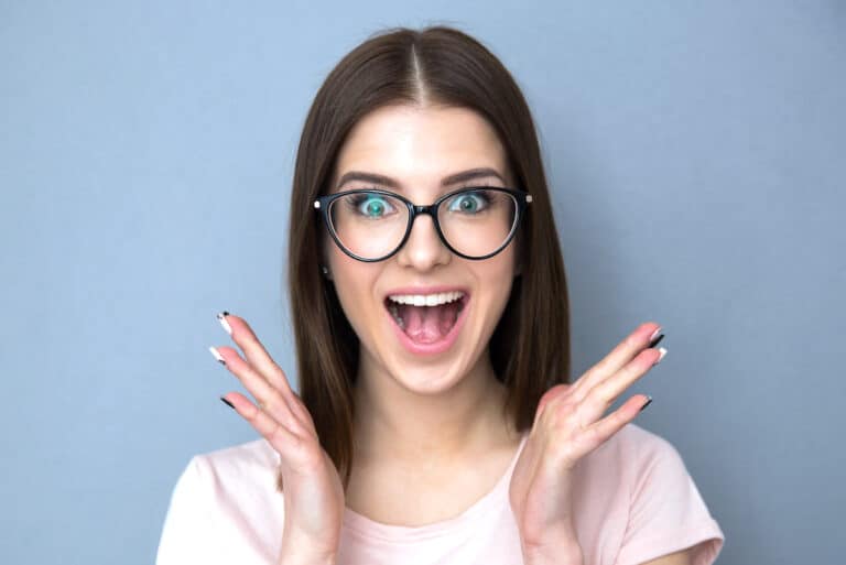 False lashes applied on a woman wearing glasses