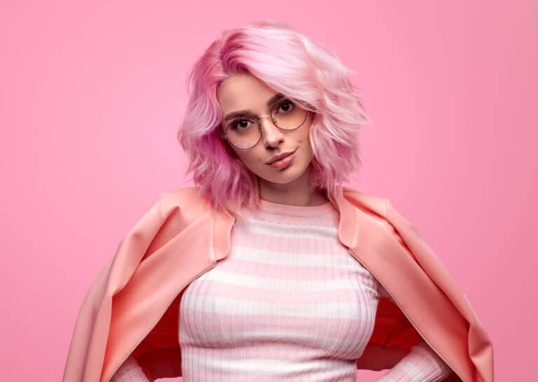 Woman with long pink dyed hair styled in loose waves
