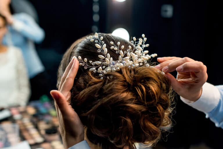 Hairstylist decorating clients hairstyle